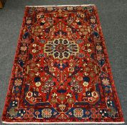 An Iranian Nahavand wool-pile patterned carpet with rust coloured reserve, 96 x 61 ins (244 x 155
