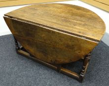 A believed early eighteenth century English oak joined gate-leg table with two end drawers. The