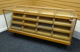 A late twentieth century light wood and glass retailer's counter display raised on a metal base with