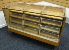 A smaller late twentieth century light wood and glass retailer's counter display raised on metal