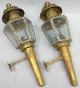 A pair of antique brass oil-burning coaching-lamps with six etched glass panes, 19.5 ins high (50