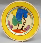 A Clarice Cliff  'Autumn' display plate in bright yellow glaze and colourful landscape to the