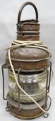 A copper ship's mast head lamp with loop handle and ribbed glass lantern (distressed), 24 ins
