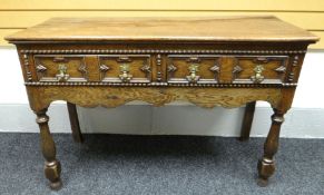 An eighteenth century and later two-drawer dresser-base with Jacobean-style geometric moulding and
