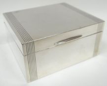 A silver covered wooden cigarette box of plain striped form, Birmingham 1952