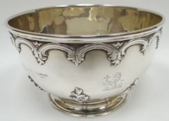 A circular-based silver footed-bowl having an embossed apron and foliage to the body and with