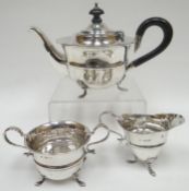 A three piece silver bachelor tea-set, each piece raised on three claw feet, Birmingham 1906/1907,