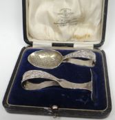 A cased silver sugar spoon and pusher Christening-set, both with loop handles and the spoon