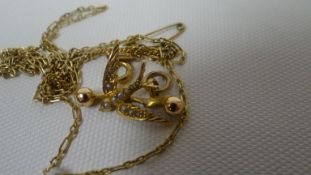 A 15ct yellow gold swallow pendant decorated with seed pearls and attached to and 18ct fine
