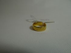 A bright-cut 22ct yellow gold wedding band, 4.5gms
