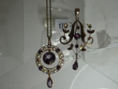 An amethyst and seed pearl hoop pendant framing a large central circular swinging amethyst and a