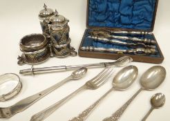 A three-piece silver and Doulton Lambeth stoneware condiment set on a non-matching Mappin & Webb