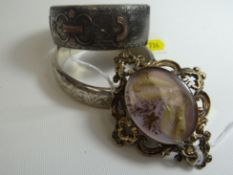 A bright-cut silver and yellow metal mounted clasp bangle, 36gms; and another, 25gms; together