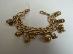 A 9ct yellow gold antique watch chain of elongated-links and with eleven attached 9ct charms,