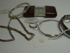 A modern pseudo-crocodile skin slide-to-view travel-clock; together with a bright-cut floral