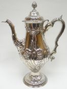 A good Irish George III silver coffee-pot, raised on a circular foot and highly decorated with