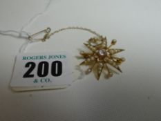 An Edwardian 15ct yellow gold seed pearl and centre diamond star brooch, 4.5gms