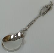 A rare Continental silver heraldic caddy spoon, decorated with a full standing knight finial upon an