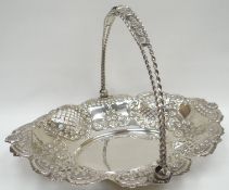 A fine quality silver swing-handled fruit-basket having pierce-work and embossed decoration to the