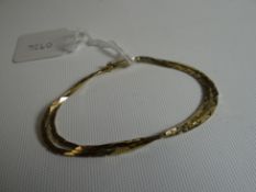 A 9ct yellow gold flat-link twin-strand bracelet, 8.1gms