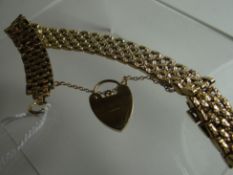 A 9ct yellow gold textured bracelet with heart-shaped padlock, 21gms