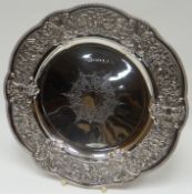 An Elizabeth II silver plate of shaped circular form with beaded rim, foliate border and radial