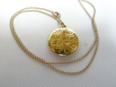 An 18ct yellow gold bright-cut circular locket and fine necklace, 6gms