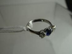 An 18ct white gold modern shank ring set with an earlier row of two diamonds and centre sapphire