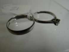A 950 platinum wedding band, 5.62gms; together with a platinum solitaire diamond ring, visual