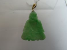 A Chinese carved jade pendant in the form of seated sage with yellow believed gold link