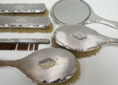 A six piece silver dressing-table set with machine turning and crimped rims and having monogrammed