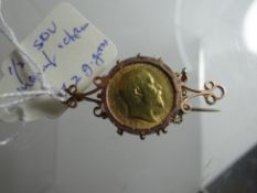 A gold half-sovereign in mount with chain, 7.2gms total