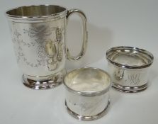 A silver Chistening mug with 'c' shaped handle and engraved with garlands and ribbons and initialled