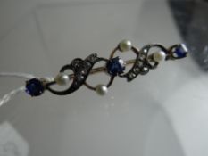 A yellow gold antique bar brooch set with three blue sapphires, four seed pearls and rows of