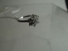 An 18ct white gold seven stone diamond cluster ring, marks for Boodle & Dunthorne (and original 1994
