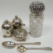 A three-piece silver condiment-set-on-stand with removable pepperette of egg-form and seated next to
