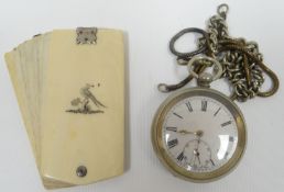 An ivory aide memoir with bird on stump decorative crest and white metal clasp; together with a