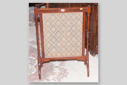 An Edwardian mahogany framed silk fronted firescreen with turned supports on arched feet, 31 x 22