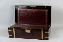 An early 19th Century flame mahogany writing slope with brass and ebony banding, nameplate and