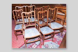 An Edwardian mahogany and inlaid seven piece salon suite of two seater couch, a pair of armchairs