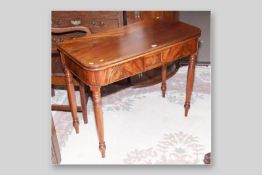 A Victorian mahogany foldover top tea table, the swivel top with bull nose edging above a frieze