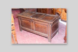 A late 18th/early 19th Century oak dower chest, the triple panelled top with bull nose edging over a