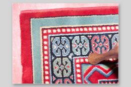 A good quality as new red patterned carpet, 90 x 66 ins (228.5 x 168 cms)