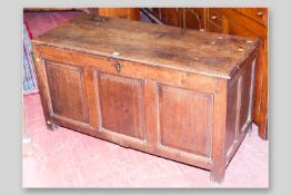 An antique oak loose lid dower chest, twin plank oak top with bull nose edge, double panelled