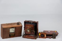 A Thornton Pickard mahogany cased bellows field camera, two mahogany plate holders, time shutter etc