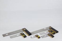 A set of ebony and brass, steel bladed set squares graduating from 14 ins (35.5 cms) to 4.25 ins (