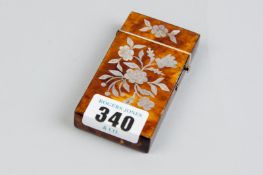 A 19th Century tortoiseshell card case with inlaid floral mother of pearl decoration