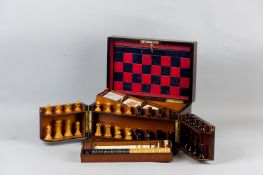 A Victorian rosewood games compendium, the lid with brass plaque and escutcheon, opening to reveal a