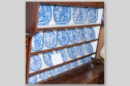A twenty four piece Willow pattern dresser set of serving platters and plates as displayed on Lot