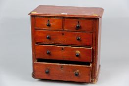 A Victorian scumbled pine chest of two short and three long drawers with brass escutcheons and